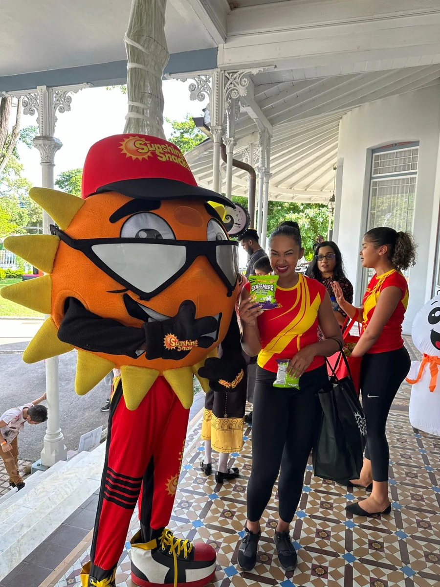 A Sunshine Snacks mascot greeting guests at the family event