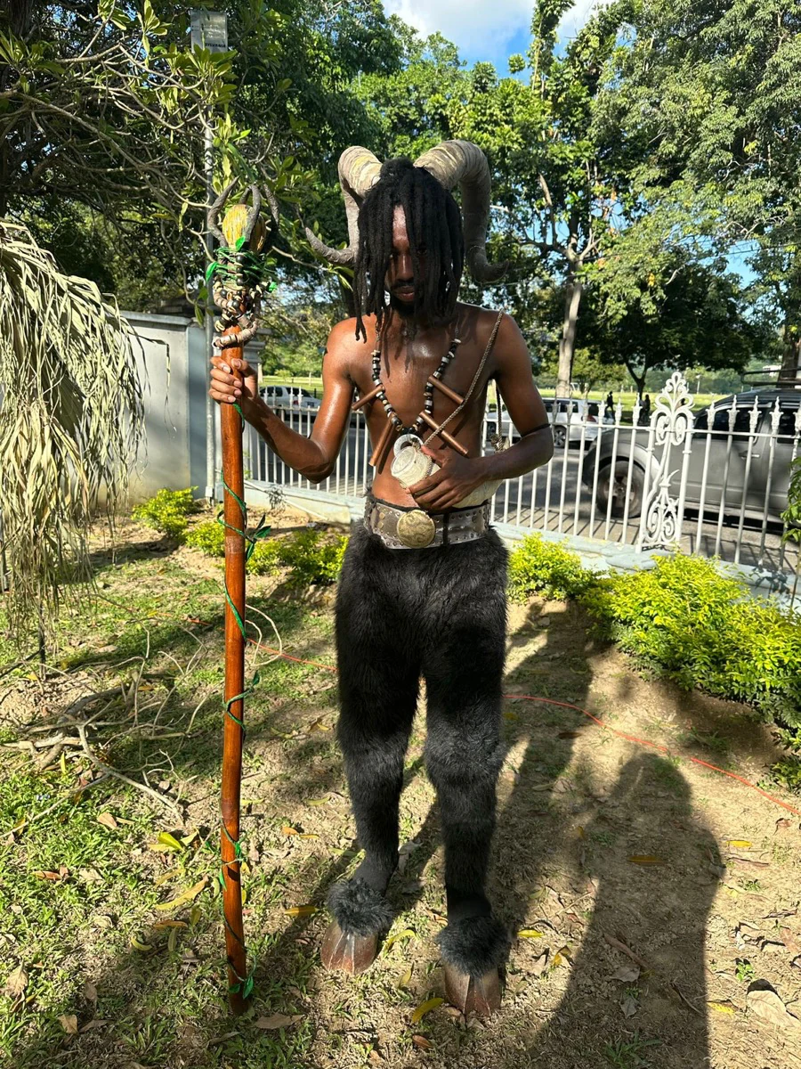 A woodland-inspired costumed performer in the event garden