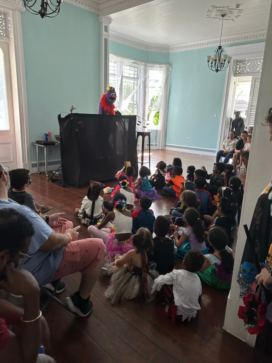 Children gathered together watching a puppet show