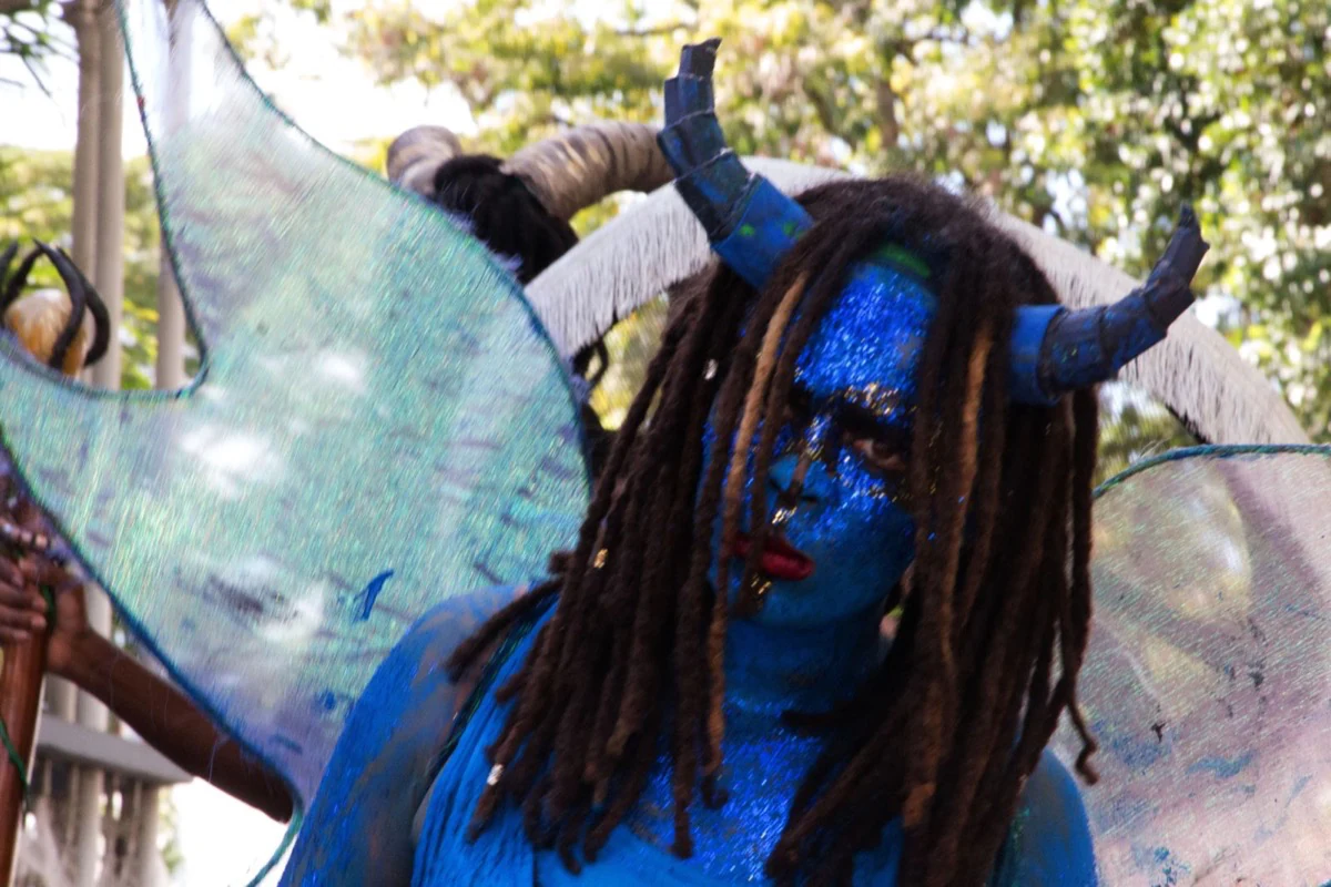 A blue fairy performer in sparkling face paint