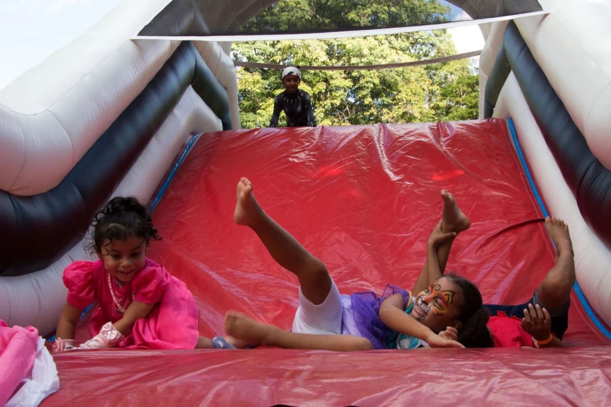 Children laughing together on an inflatable slide