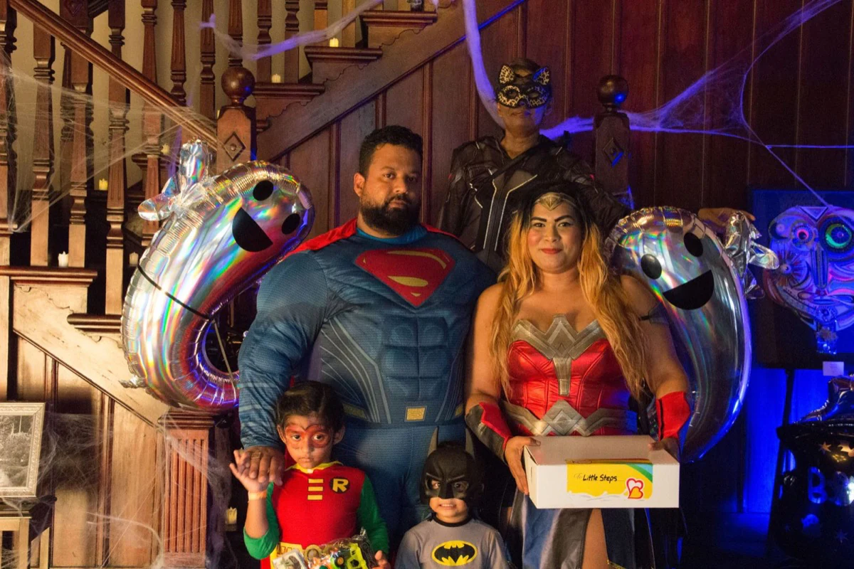 A superhero family portrait inside the decorated venue