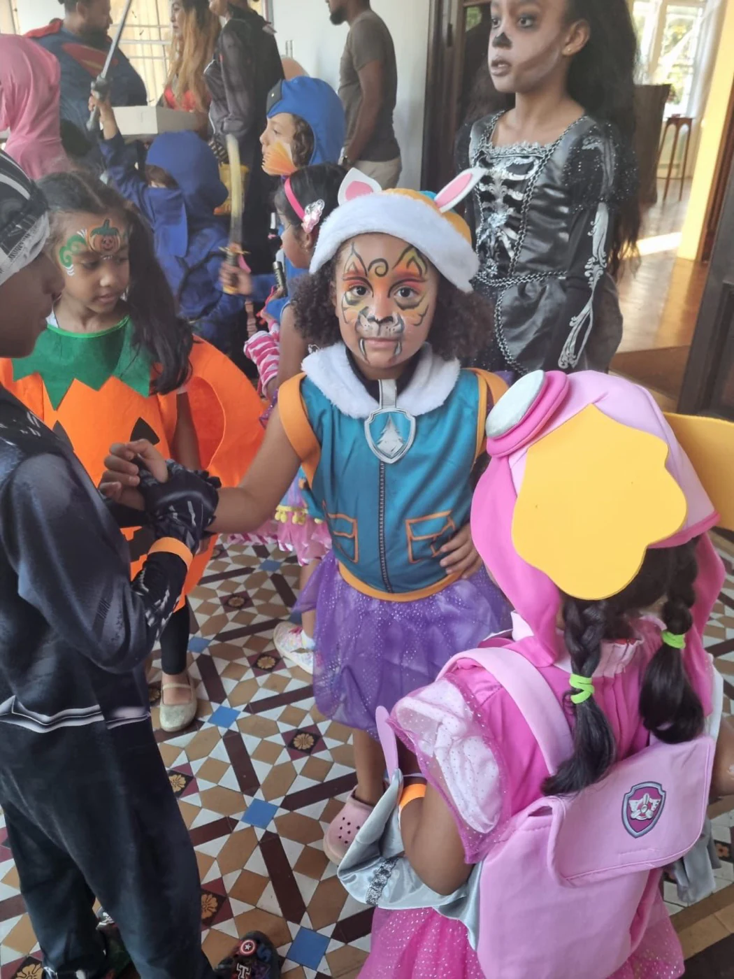 Children showing their colourful costumes and face painting